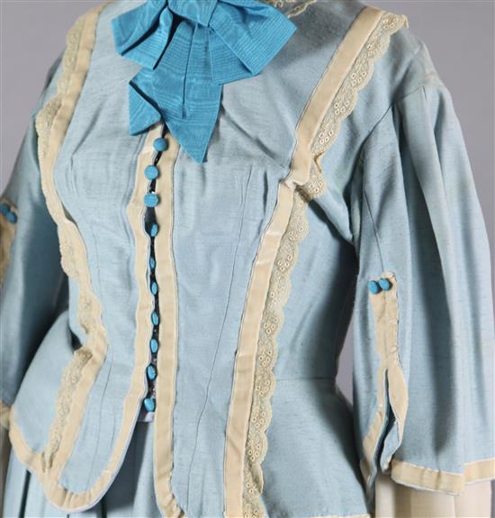 Rigoletto: A rail with a pale blue skirt and jacket, a quantity of royal blue gold braided jackets and trousers,